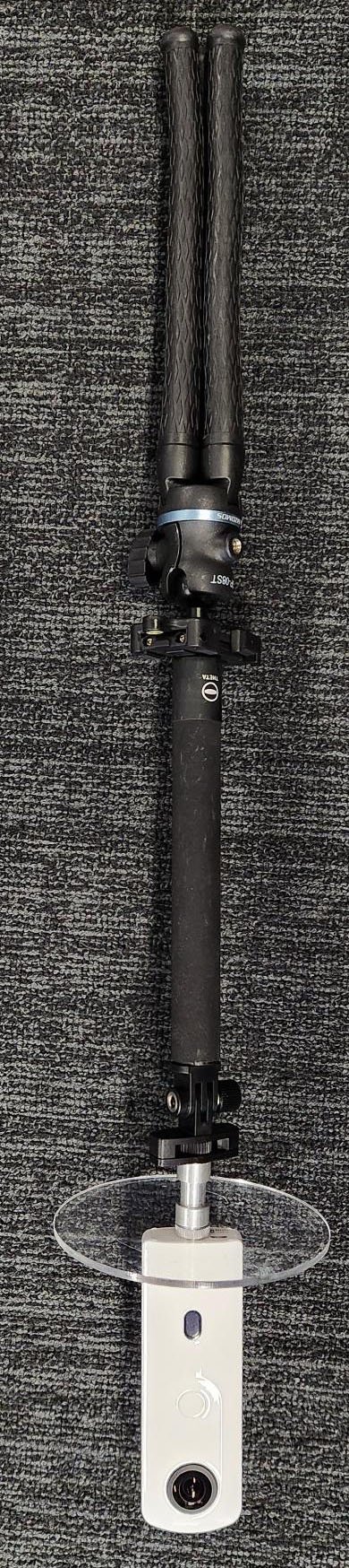 360 camera with accessories: an acrylic disk, selfie stick and tripod.